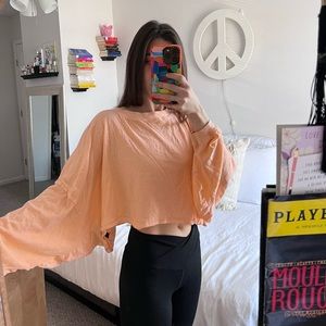 out from under peach colored long sleeve. blouse size small. urban outfitters.